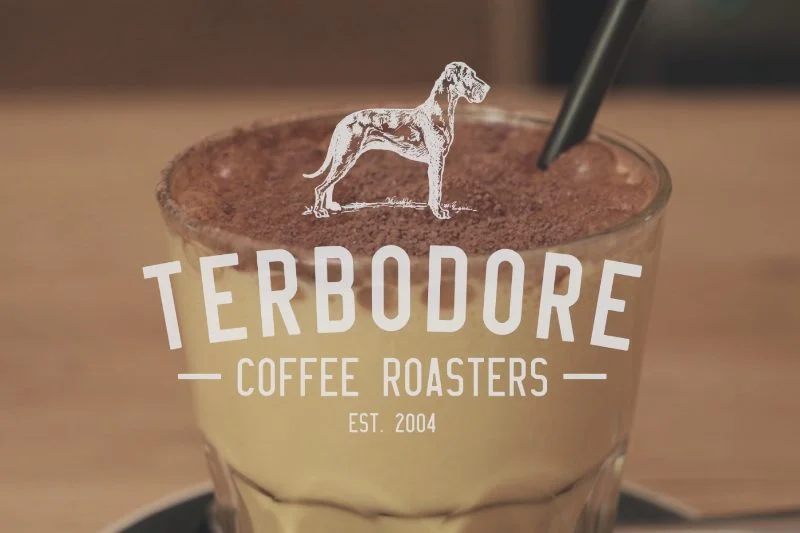 Terbodore Coffee Roasters logo with iced coffee in background