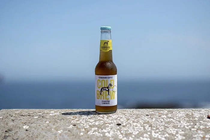 Terbodore Sparkling cold brew on a wall overlooking the sea