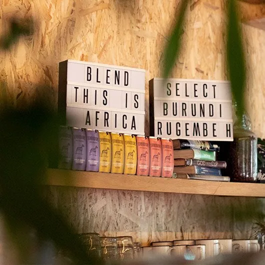 Signs on a shelf with Terbodore Coffee - Terbodore Cafe Franschhoek